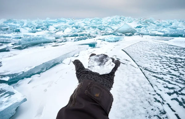 Open Hand Glove Holding Small Transparent Piece Ice Frozen Lake — Foto de Stock