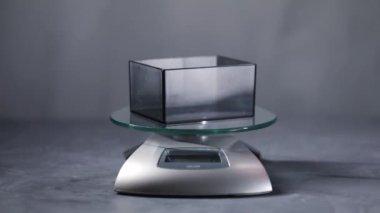 Fresh roasted coffee beans falling to scales