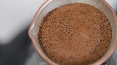 Making Turkish coffee in copper cezve
