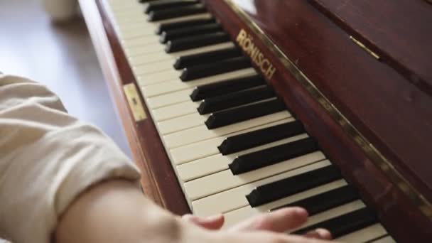 Жінка грає на старовинному дерев'яному піаніно — стокове відео
