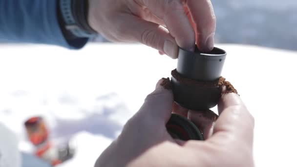 Grind coffee capsule outdoor winter mountain — Stock Video