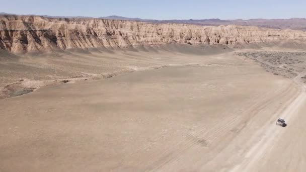 Drone shot offroad car riding in Canyon desert mountains — Video