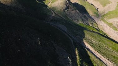 Aerial drone landscape reveal shot of snow summit and road at mountain valley in Almaty Kazakhstan