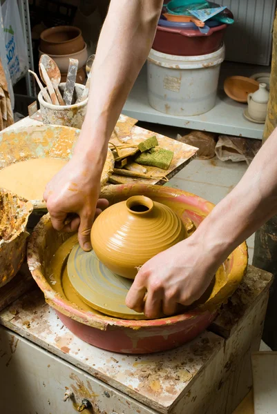 Hands of a potter, creating an earthen jar on the circle — Stock Photo, Image