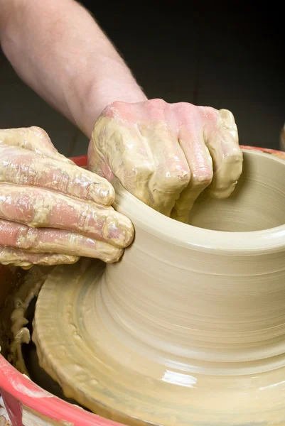 Hands of a potter, creating an earthen jar on the circle — Stock Photo, Image