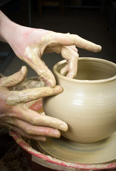 Handen van een pottenbakker, het creëren van een aarden pot op de cirkel — Stockfoto