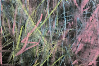 Çocuk tebeşir ile bir tahtaya çizer.