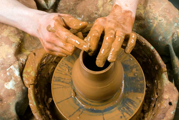 Hands of a potter, creating an earthen jar on the circle — Stock Photo, Image