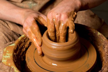 hands of a potter, creating an earthen jar clipart