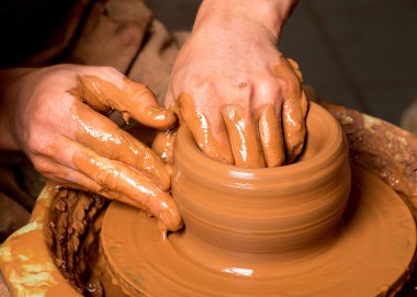 hands of a potter, creating an earthen jar clipart