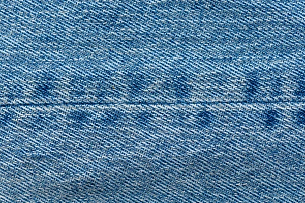 Jeans närbild bakgrund. Denimsömmar. Blå tyg — Stockfoto