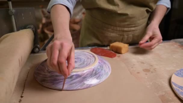 Master ceramist works in pottery studio. Process of creating plate — Stock Video