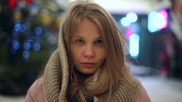 Young beautiful girl portrait in winter jacket with fur hood outdoor — Stock Video
