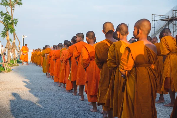 タイのプーケットにある大仏殿近くのオレンジの服を着た若い仏教徒。2019年4月28日 — ストック写真