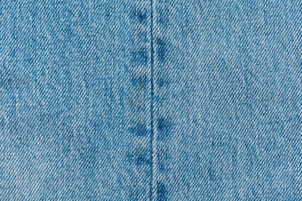 Jeans närbild bakgrund. Denimsömnad — Stockfoto