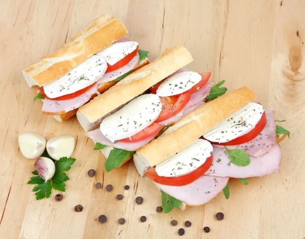 Fresh sandwiches with tomato , ham and mozzarella isolated on wh — Stock Photo, Image