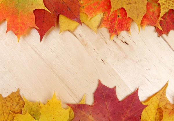 Autumn leaves on wooden background texture — Stock Photo, Image