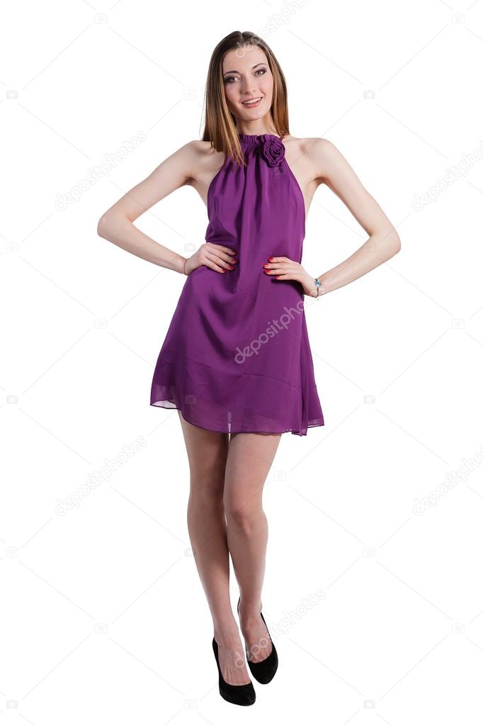 Beautiful female fashion model posing in purple dress