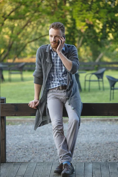 Модный парень разговаривает по мобильному телефону — стоковое фото