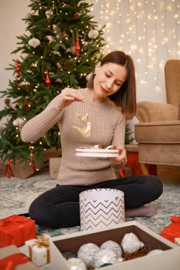 Noel hediyelerini paketleyen kadın.