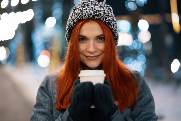 Lächelnde junge Frau genießt eine Tasse Kaffee im Freien — Stockfoto