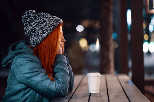 Sorrindo jovem mulher desfrutando de uma xícara de café ao ar livre — Fotografia de Stock