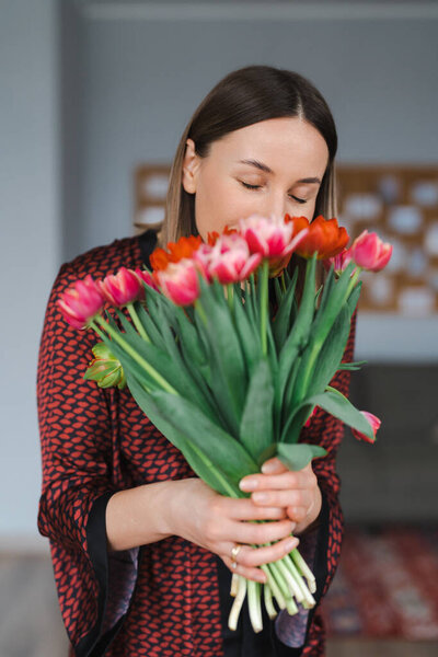Young woman enjoy flowers at home