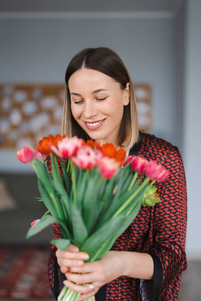 Young woman enjoy flowers at home