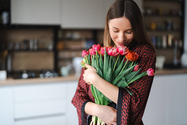 Young woman enjoy flowers at home