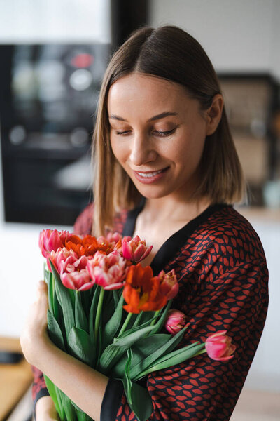 Young woman enjoy flowers at home