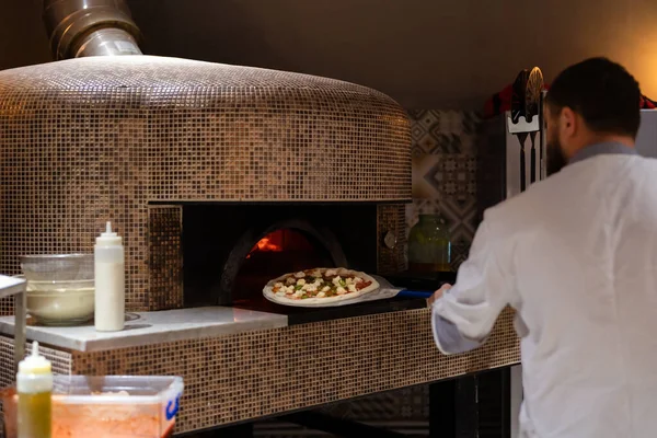 Pizza oven burning in flames getting ready to bake pizza Stock Image