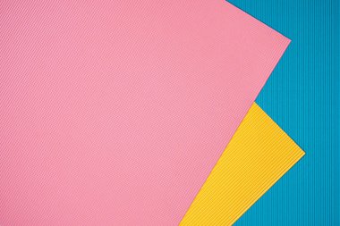 Blue, pink and orange three tone color paper background with stripes. Abstract background modern hipster futuristic. Texture design