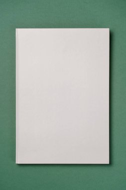 Gray Leather notebook on paper green background, notepad mock up, top view shot