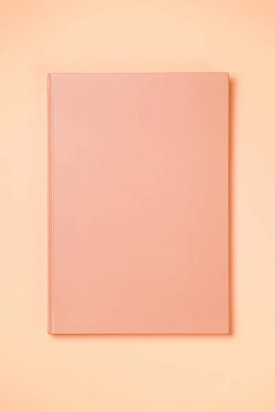 Leather notebook cover on a paper orange background, notepad mock up, top view shot