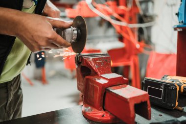 Keskin kıvılcımlarla metal kesen bir teknisyen. Kedi demiri için ekipman kullanılıyor.