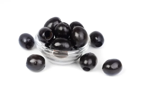 Black pitted olives in glass isolated on white macro — Stock Photo, Image