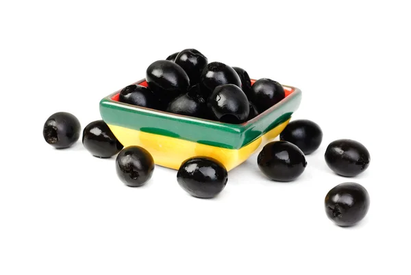 Vypeckované černé olivy v keramická mísa kompotová izolovaných na bílém makro — Stock fotografie