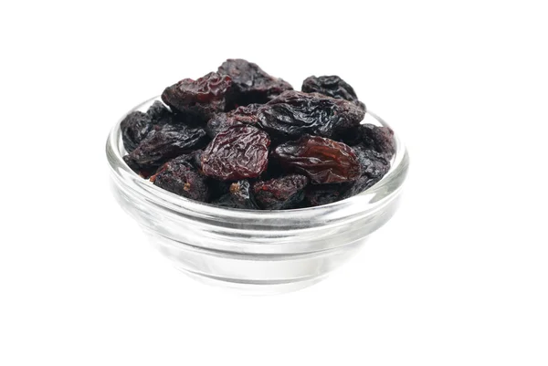 Dark raisins close- up in glass bowl isolated on white background — Stock Photo, Image