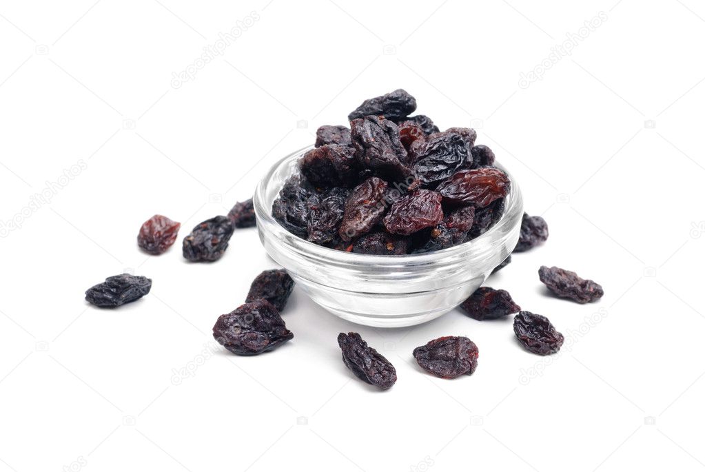 dark raisins close- up in glass bowl isolated on white background