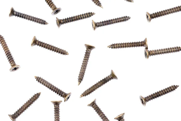 Brass screws on a white as fine background — Stock Photo, Image