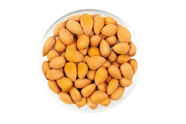 Dried almonds on glass bowl isolated on a white background — Stock Photo, Image