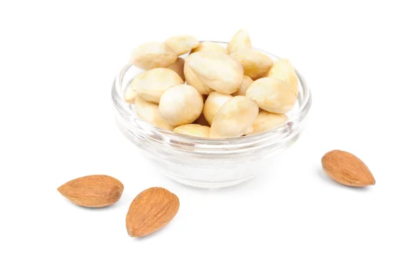 Dried peeled almonds on glass bowl isolated on a white background — Stock Photo, Image