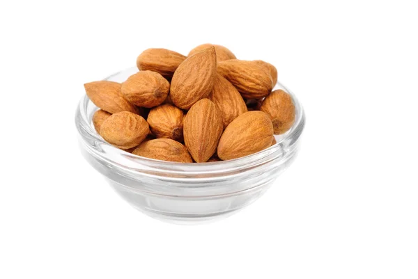 Dried almonds on glass bowl isolated on a white background — Stock Photo, Image