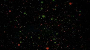 Siyah arkaplanda gümüş pullu yuvarlak renkli toplar. Kırmızı ve yeşil parçacıklar rastgele hareket eder.