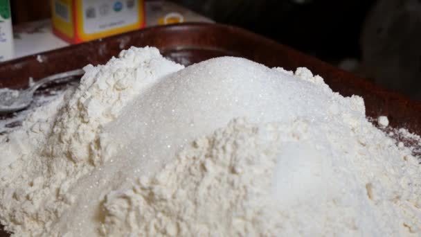 가정에서 만든 콜로 복 불알을 굽기 위한 밀가루에 설탕 과 식물성 기름을 첨가 한다. 재료를 금속 식탁보와 혼합하는 일. — 비디오