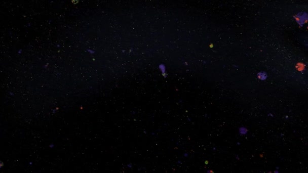 Rounded red, yellow and purple balls on a black background with sequins. — Stock Video