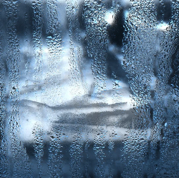 Blue lights through wet misted glass — Stock Photo, Image