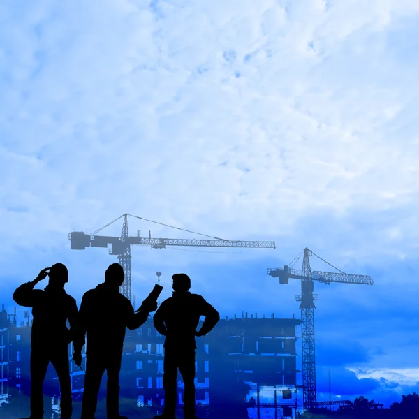 Builders against the background construction — Stock Photo, Image