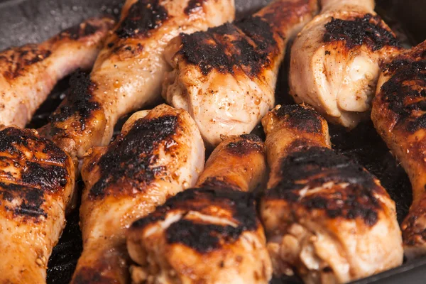 Some roast chicken drumstick on frying pan — Stock Photo, Image