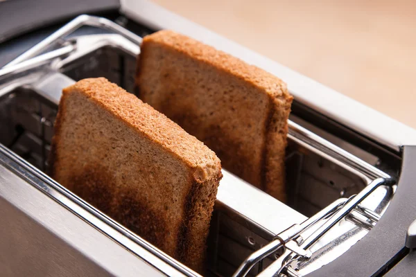 Two hot bread toast in toaster — Stock Photo, Image